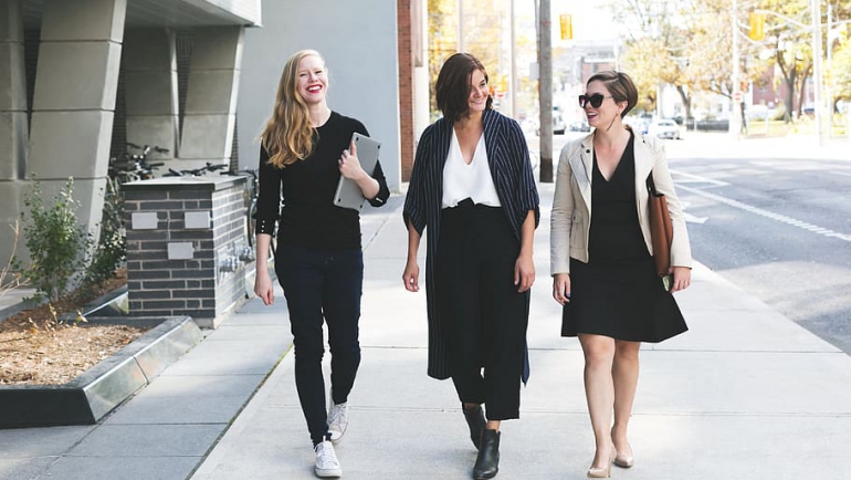 Three Women Walking happily on the Street