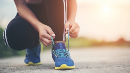 A woman Tying her shoes